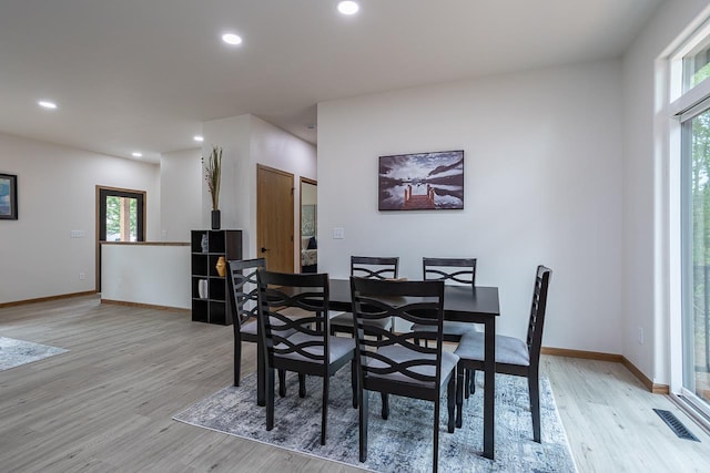 dining space with light hardwood / wood-style flooring