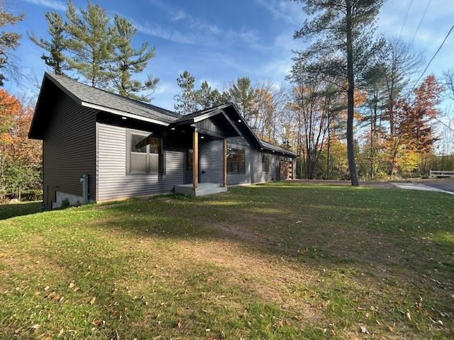 view of side of home featuring a lawn