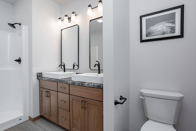 bathroom with toilet, walk in shower, wood-type flooring, and vanity