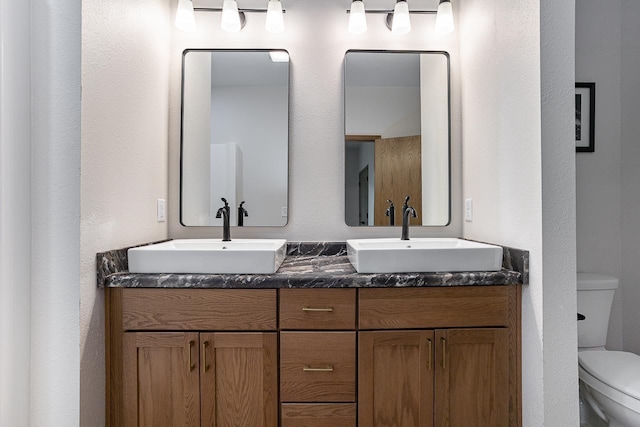 bathroom featuring toilet and vanity