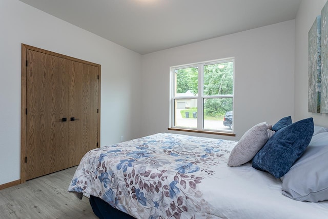 bedroom featuring a closet and light hardwood / wood-style flooring