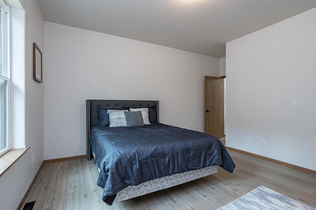 bedroom with light hardwood / wood-style flooring