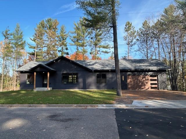 view of front of home with a garage and a front yard