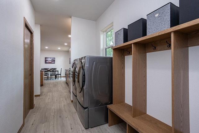 washroom featuring light wood-type flooring and washing machine and dryer