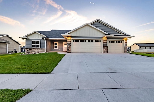 craftsman inspired home with a yard and a garage