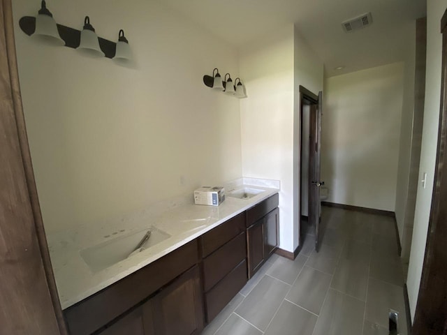 bathroom featuring tile patterned flooring and vanity