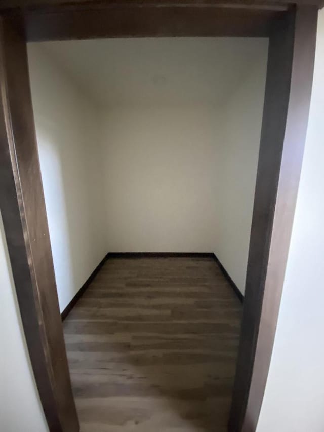 empty room with dark hardwood / wood-style floors