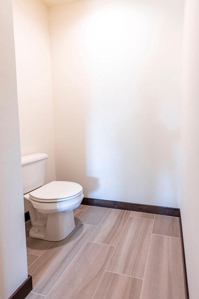 bathroom featuring hardwood / wood-style floors and toilet