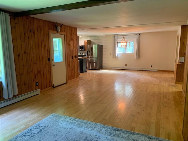 unfurnished living room featuring a baseboard heating unit, light hardwood / wood-style flooring, beam ceiling, and wooden walls