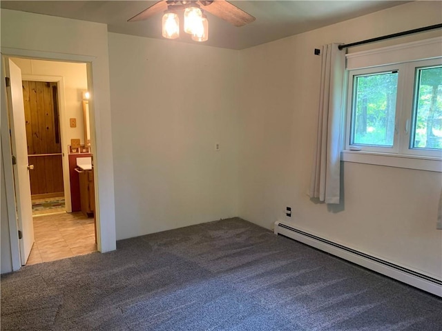 unfurnished room with ceiling fan, a baseboard radiator, and light carpet