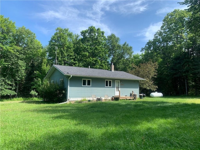 rear view of house featuring a yard