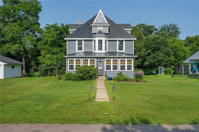 victorian home with a trampoline and a front yard