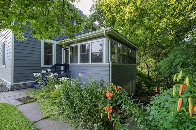 view of side of property featuring a sunroom