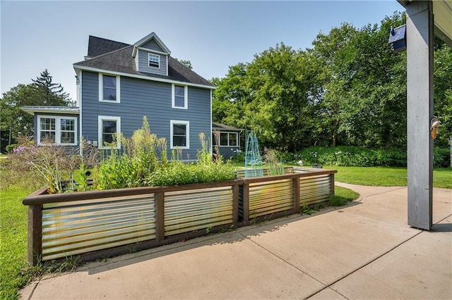 rear view of property with a lawn