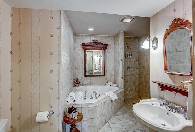 bathroom with sink, independent shower and bath, and tile patterned flooring