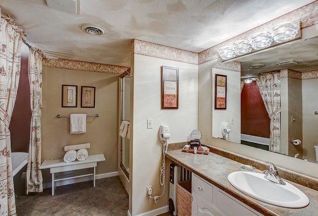 bathroom with curtained shower and vanity