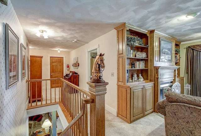 hall featuring crown molding and light colored carpet