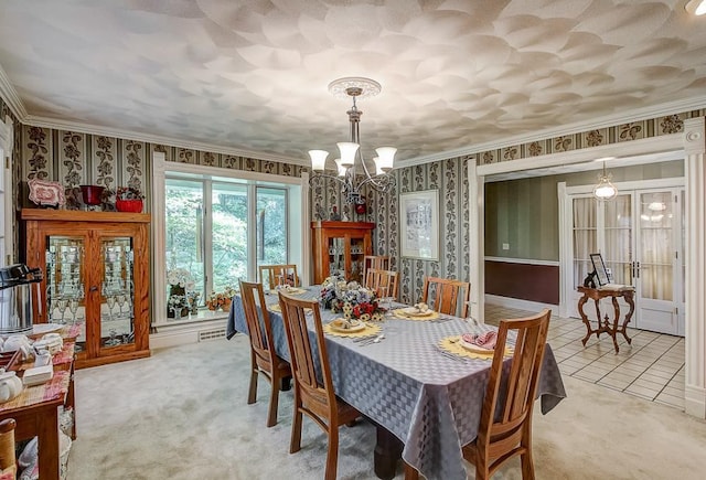 dining area featuring light carpet, a chandelier, crown molding, and french doors