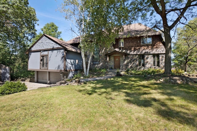 view of front of home with a front lawn and a garage