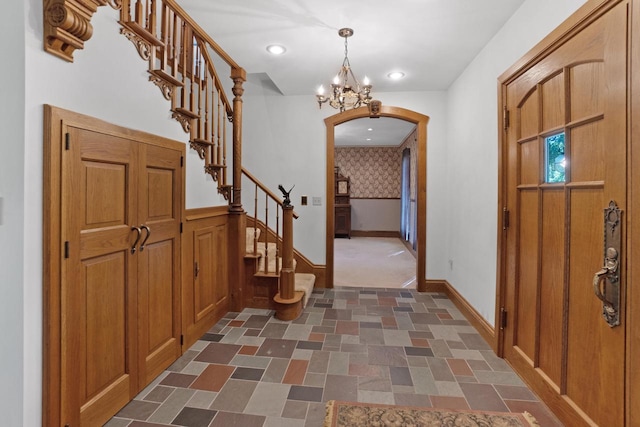 foyer entrance with an inviting chandelier