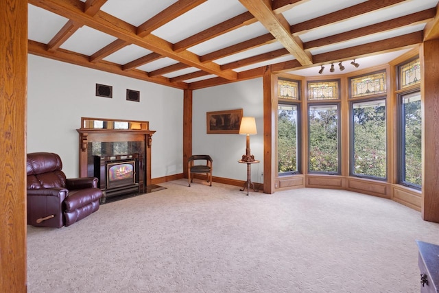 living area featuring carpet floors, beam ceiling, a fireplace, and coffered ceiling