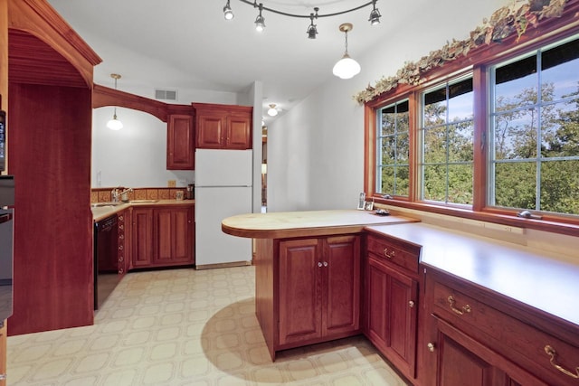 kitchen with white fridge, black dishwasher, pendant lighting, and kitchen peninsula