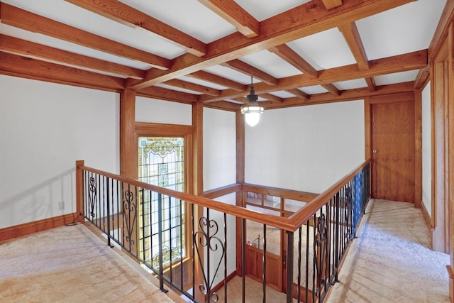 corridor with light colored carpet, beamed ceiling, and coffered ceiling