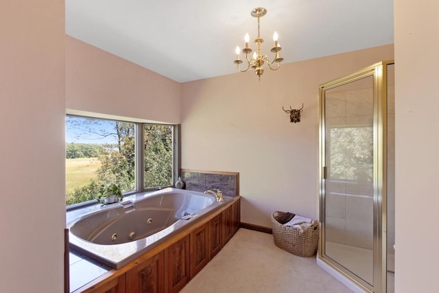 bathroom featuring a chandelier and separate shower and tub