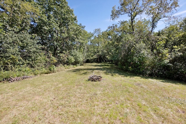 view of yard with a fire pit