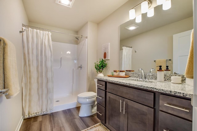 bathroom featuring toilet, vanity, walk in shower, and hardwood / wood-style floors