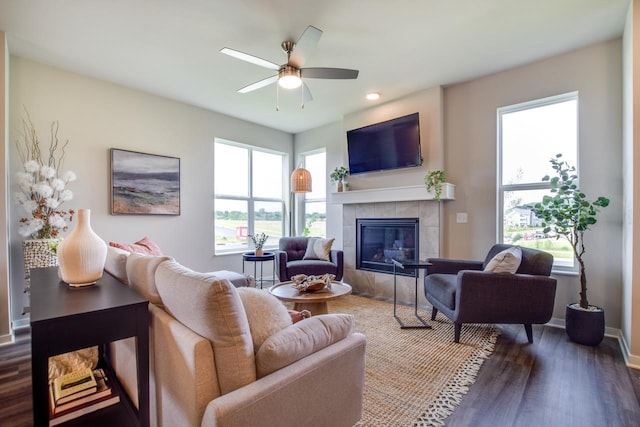 living room featuring ceiling fan, a fireplace, and hardwood / wood-style floors