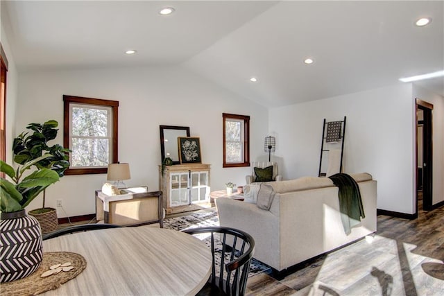 living room featuring lofted ceiling and hardwood / wood-style floors