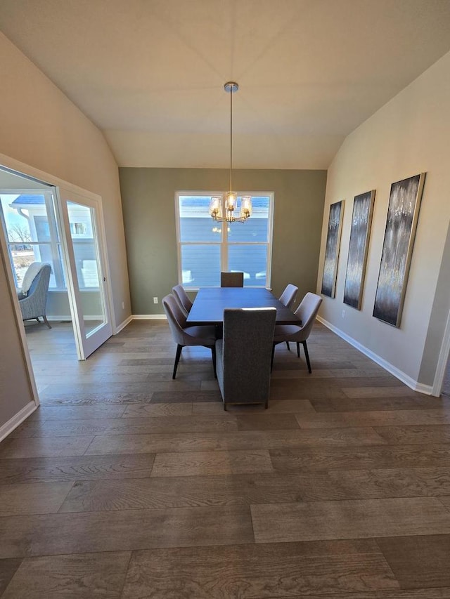 dining room with dark hardwood / wood-style flooring, a notable chandelier, and vaulted ceiling