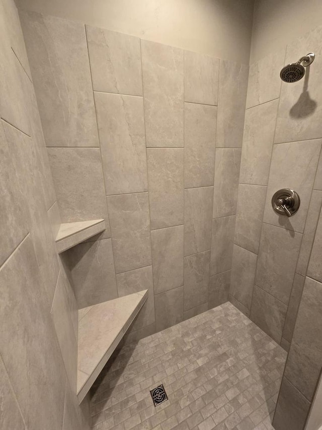 bathroom with a tile shower