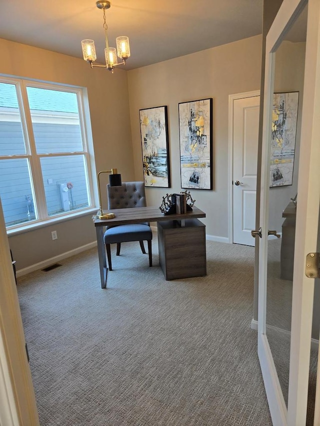 office area with carpet floors, a healthy amount of sunlight, and an inviting chandelier