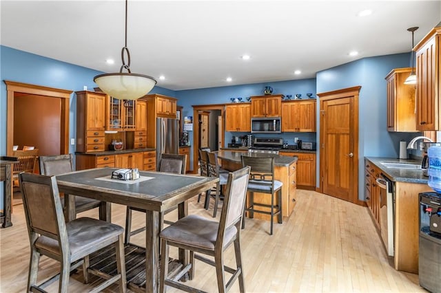 dining area featuring sink and light wood-type flooring