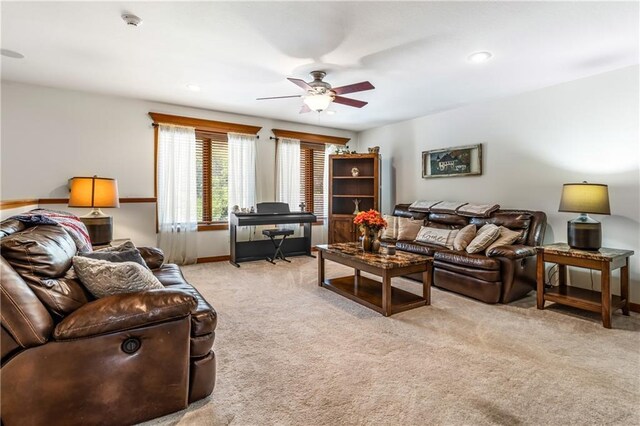 carpeted living room featuring ceiling fan