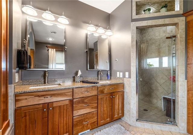 bathroom featuring vanity, tile patterned flooring, and walk in shower