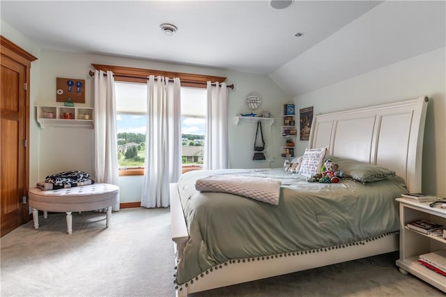 bedroom featuring lofted ceiling and light carpet