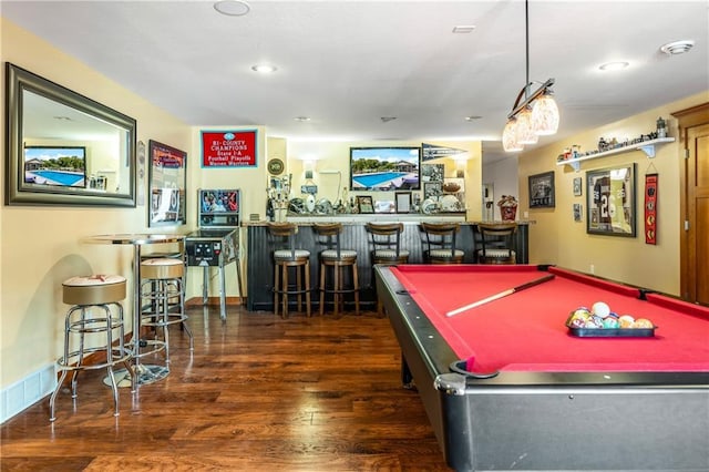 recreation room with dark hardwood / wood-style floors and bar area