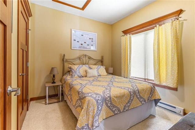 carpeted bedroom with a baseboard heating unit