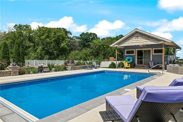 view of swimming pool with ceiling fan and a patio