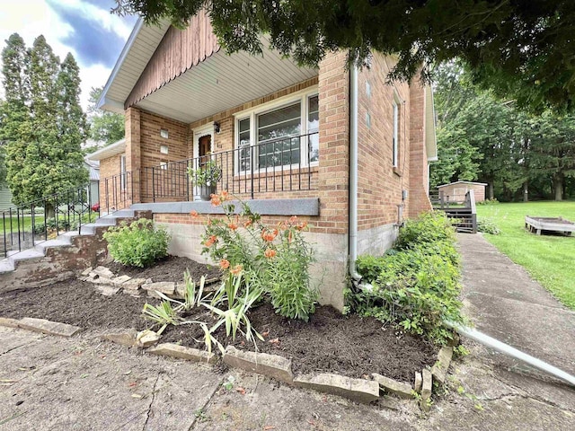 view of front of house with covered porch and a storage shed