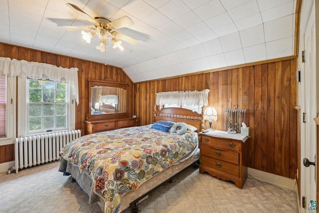 bedroom featuring ceiling fan, lofted ceiling, radiator, and light carpet