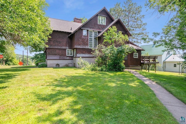 exterior space featuring a lawn and a deck