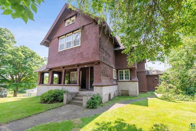 view of front of house featuring covered porch and a front yard