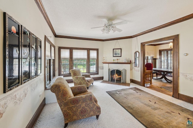 carpeted living room with ceiling fan, crown molding, and a textured ceiling