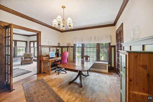 office featuring ornamental molding, an inviting chandelier, and light hardwood / wood-style floors