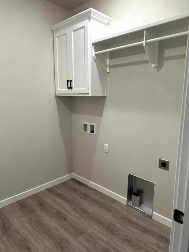 clothes washing area featuring hookup for a washing machine, dark hardwood / wood-style flooring, hookup for an electric dryer, and cabinets