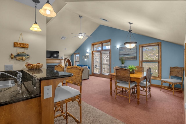650 S Pier Dr Unit 2, Sheboygan, WI 53081 - dining room featuring ceiling fan, high vaulted ceiling, sink, and light carpet
